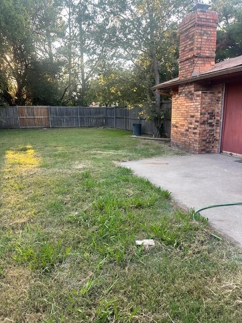 2736 Chebi Lane Denton, TX 76209 - Photo 17 of 17 a view of a backyard with a barbeque and a large tree