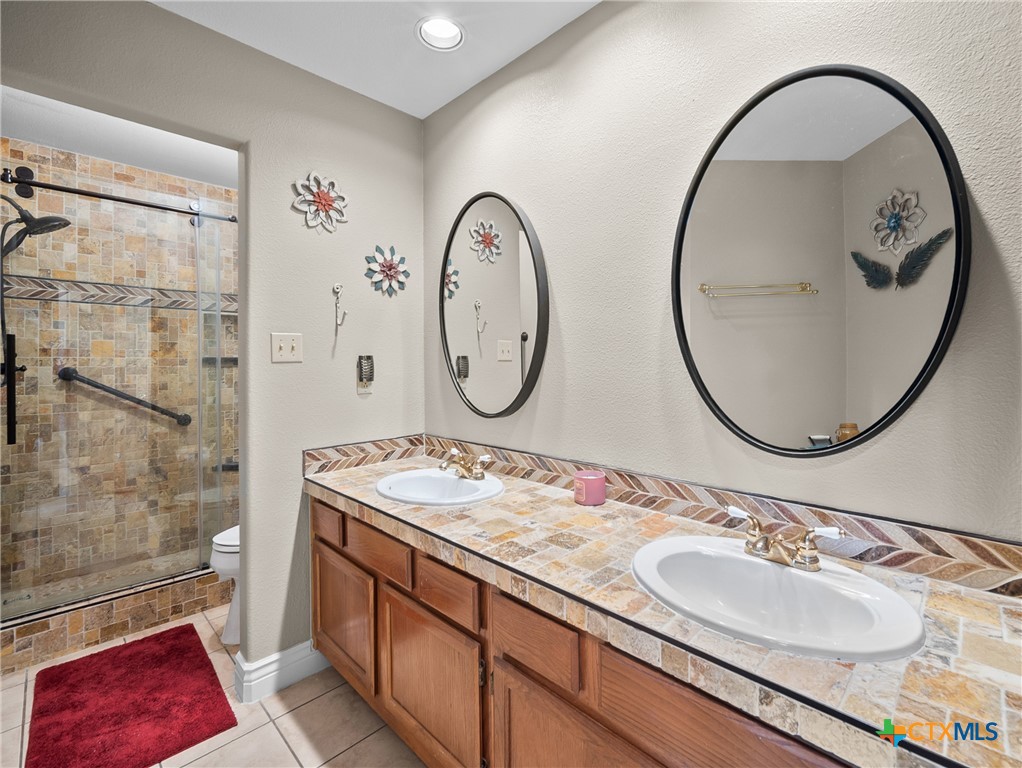 782 Santa Clara Loop Marion, TX 78124 - Photo 44 of 48 a bathroom with a sink and a mirror