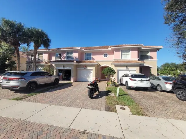 an aerial view of a house with garden space and street view