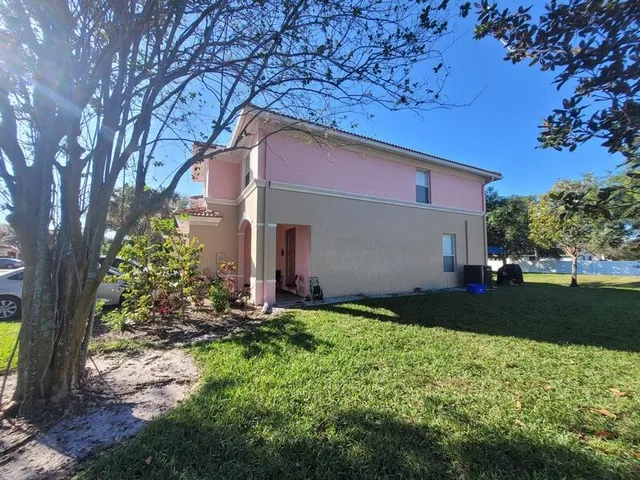 an aerial view of a house with yard swimming pool and outdoor seating