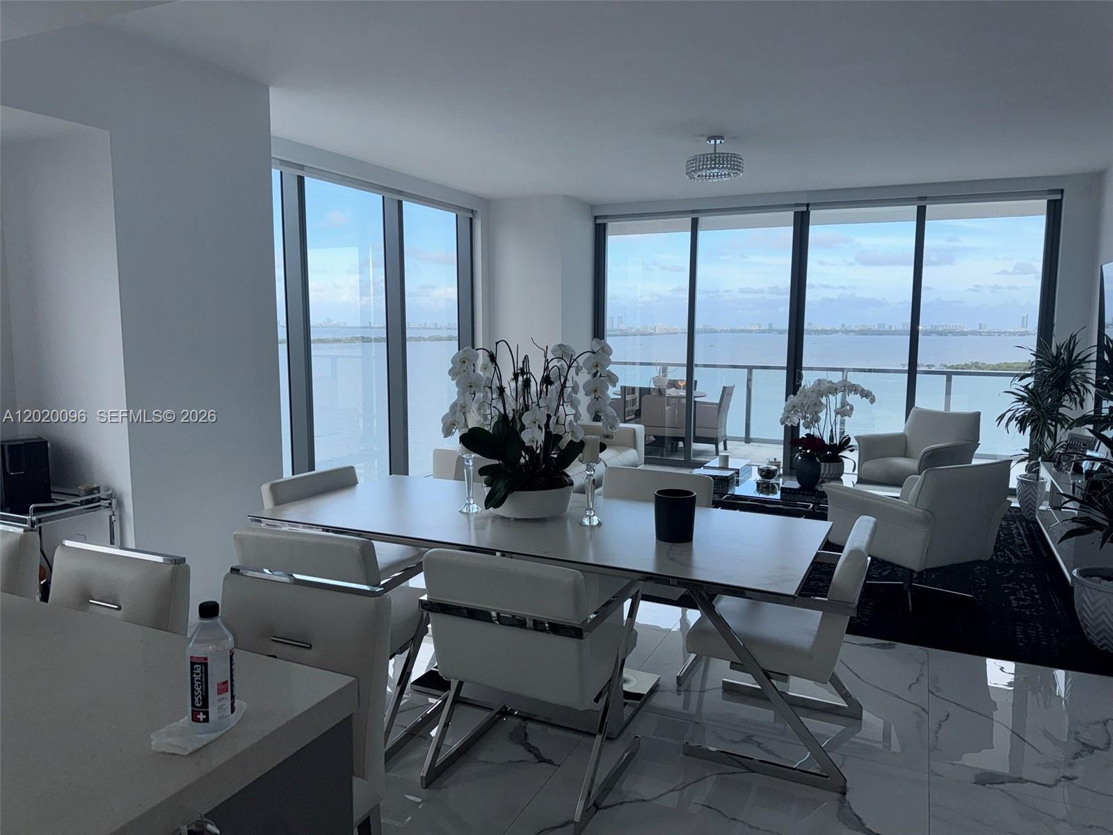 788 Northeast 23rd Street, Unit 1202 Miami, FL 33137 - Photo 1 of 64 a dining room with furniture a large window and a chandelier