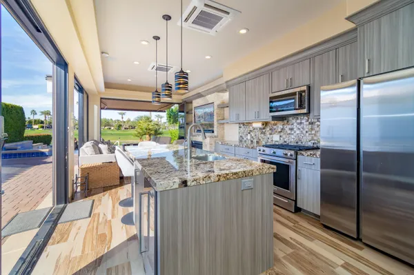 a living room with patio furniture and a large window