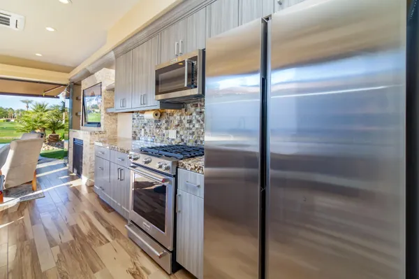 a kitchen with kitchen island granite countertop a stove and a sink