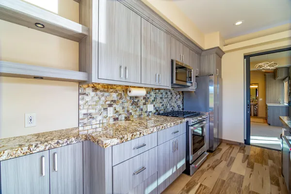 a bathroom with a sink a mirror and shower