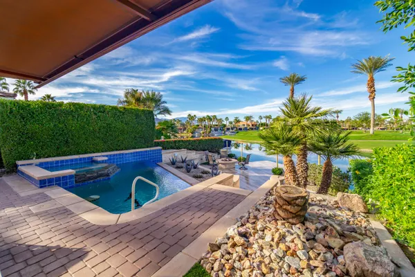 a view of a backyard with sitting area