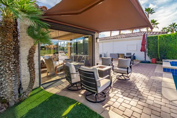 a view of a backyard with a sitting area