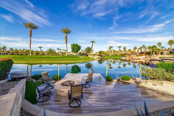 an aerial view of a house yard swimming pool and outdoor seating