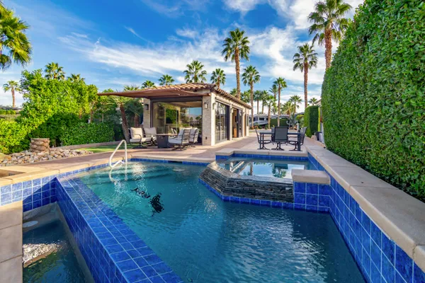 an aerial view of a house with a garden and lake view