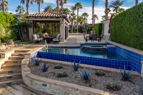 a view of a swimming pool with a table and chairs