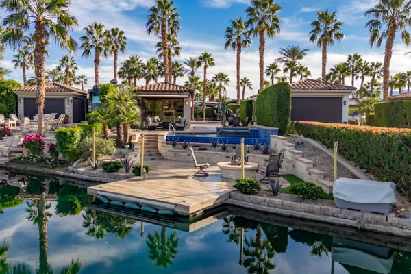 a view of a swimming pool with a yard and lake view