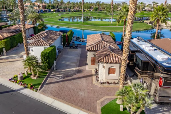 a kitchen with kitchen island granite countertop a sink and a refrigerator