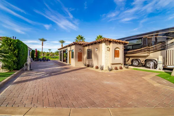 a kitchen with stainless steel appliances granite countertop a refrigerator a sink and a stove