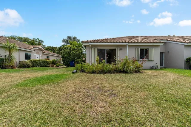 a front view of house with yard and trees