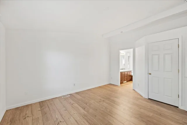 a view of an empty room and wooden floor