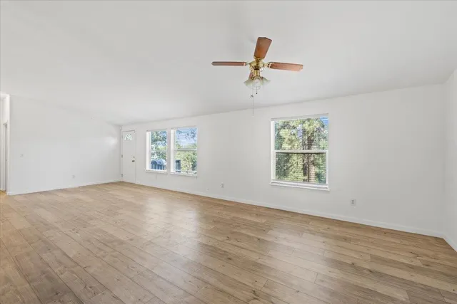 wooden floor in an empty room with a window