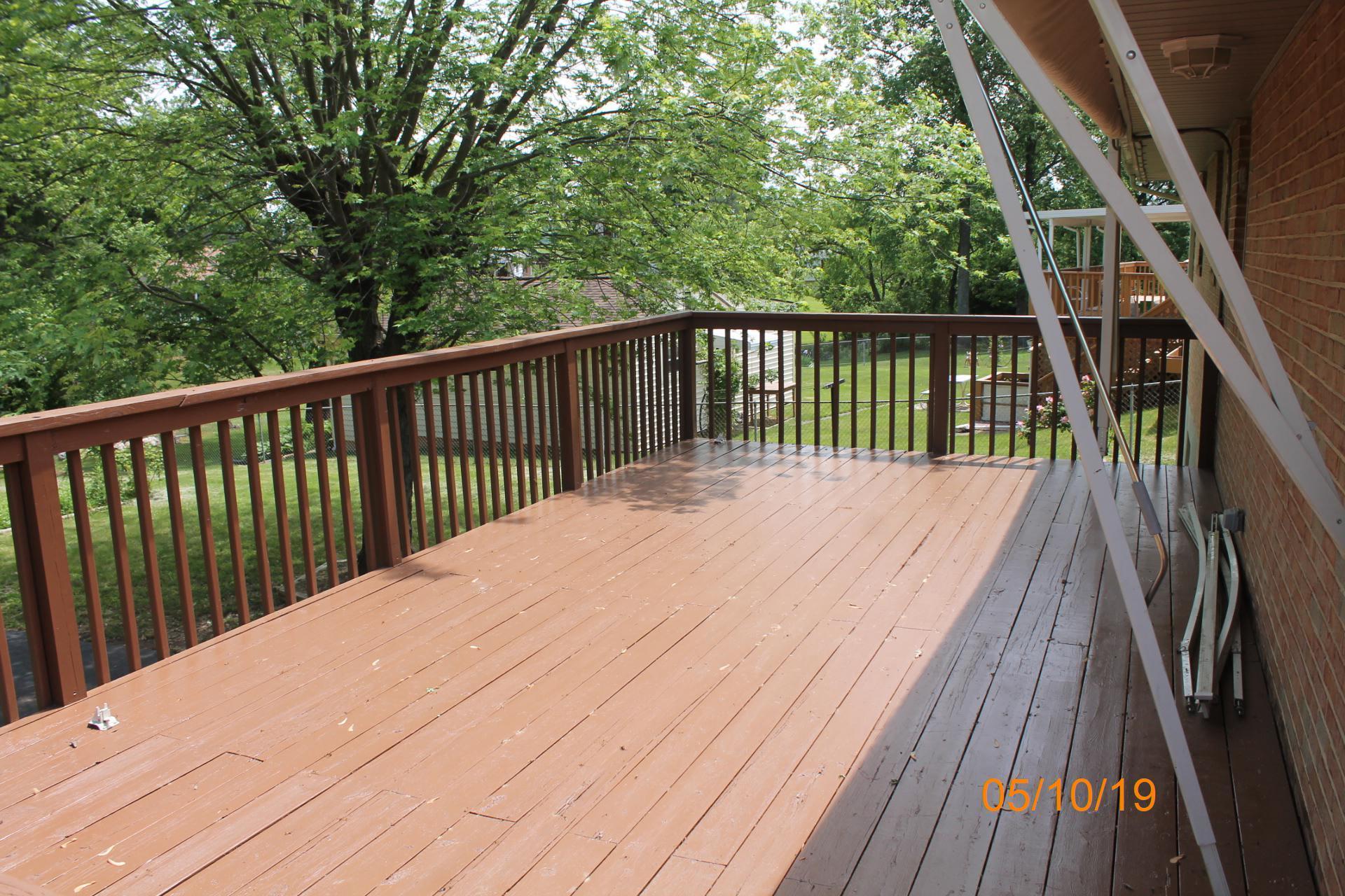 745 Kenyon Road Vinton, VA 24179 - Photo 15 of 52 a balcony with wooden floor and trees in the back