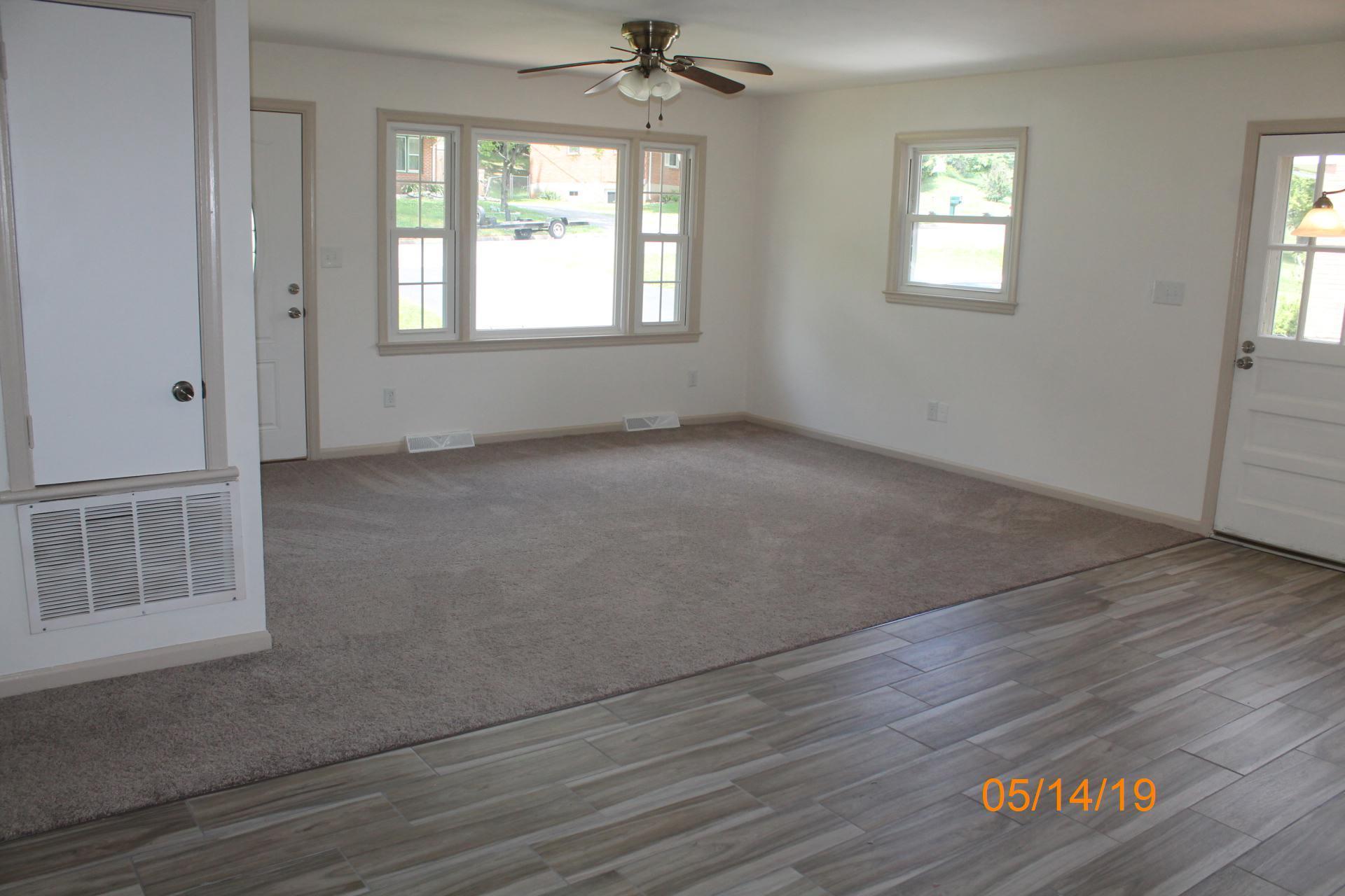 745 Kenyon Road Vinton, VA 24179 - Photo 17 of 52 an empty room with wooden floor cabinet and windows
