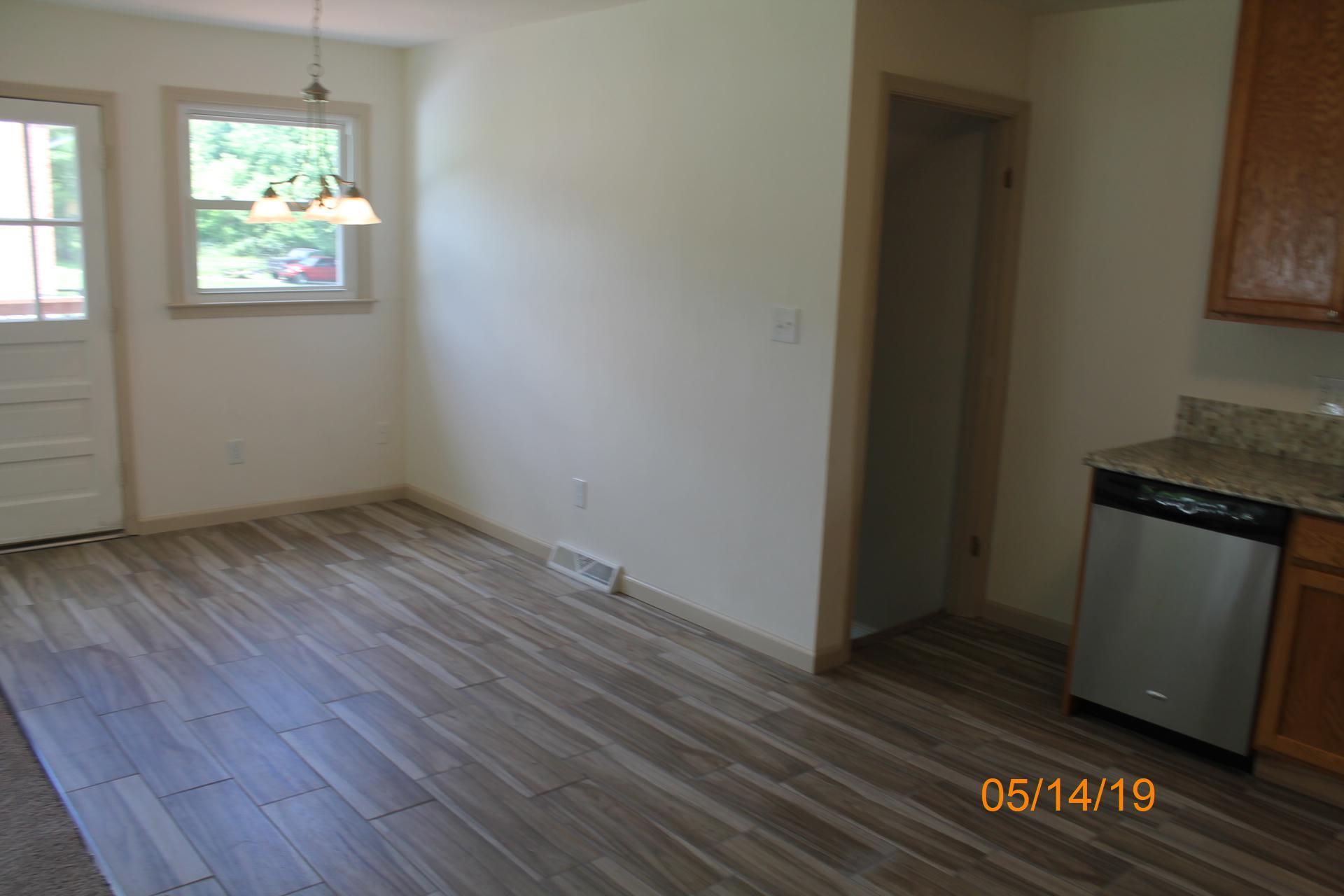 745 Kenyon Road Vinton, VA 24179 - Photo 22 of 52 an empty room with wooden floor and windows