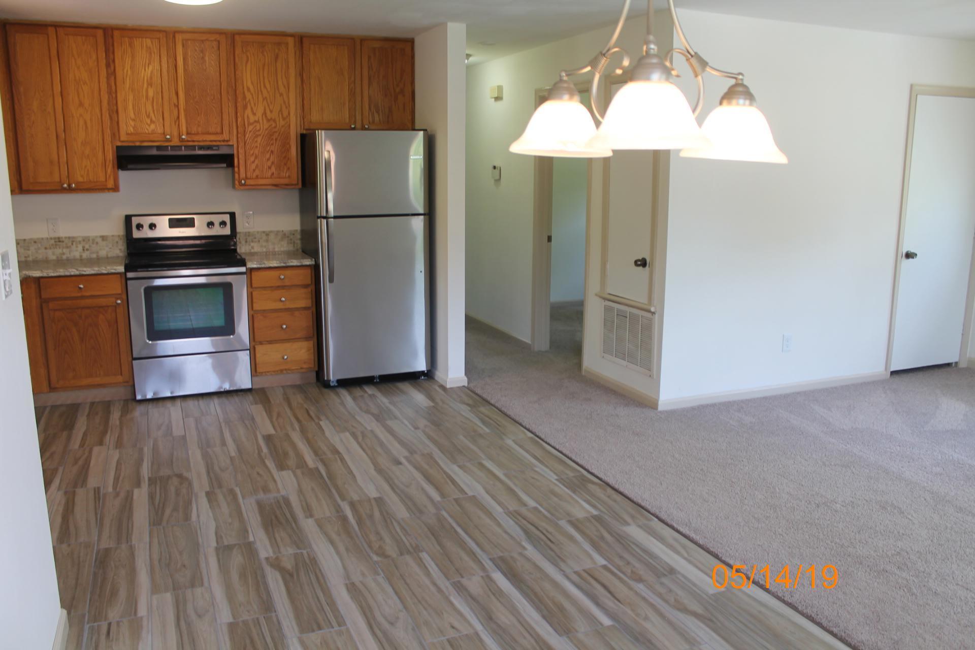 745 Kenyon Road Vinton, VA 24179 - Photo 28 of 52 a kitchen with kitchen island wooden floors and stainless steel appliances