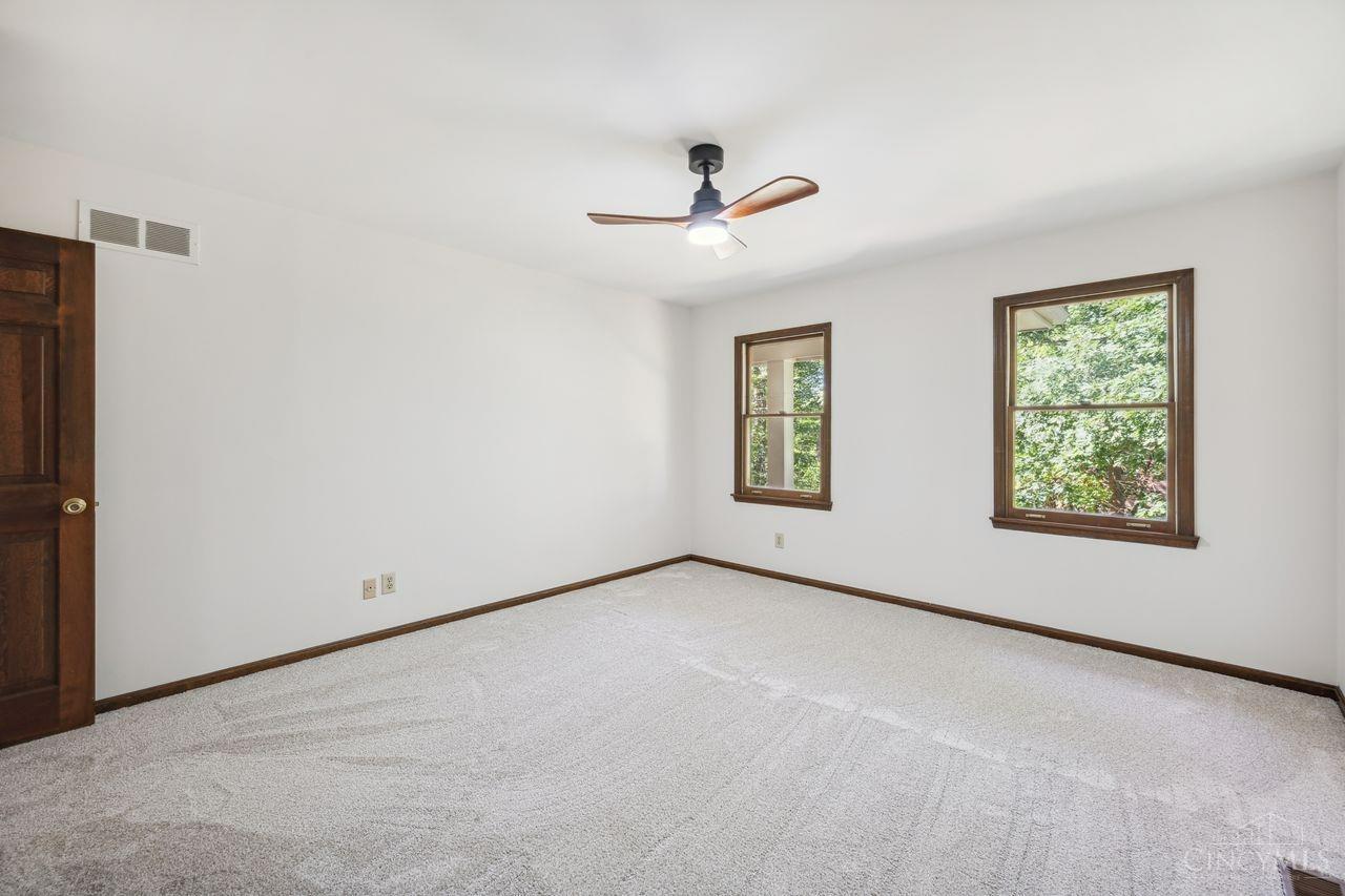 8589 Weller Road Montgomery, OH 45249 - Photo 20 of 30 The second bedroom is large with two windows and the ceiling fan stirs the air.
