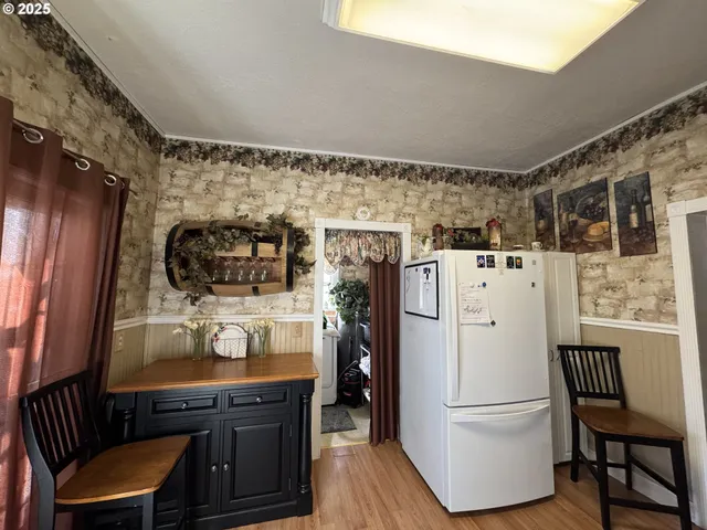 a kitchen with stainless steel appliances a refrigerator and a stove top oven