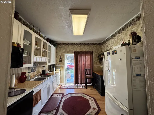a kitchen with stainless steel appliances granite countertop a refrigerator and a stove top oven