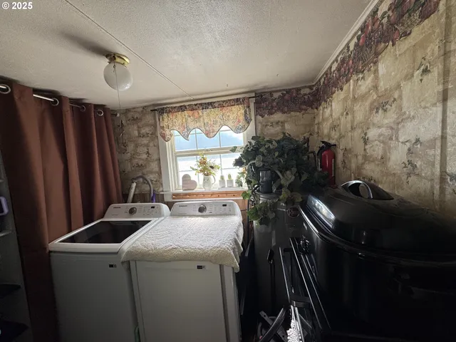a room with sink dryer and washer