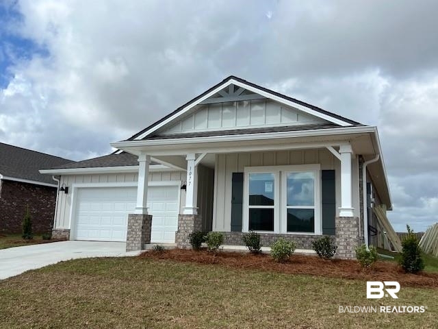 1077 Hayward Loop Foley, AL 36535 - Photo 1 of 35 Craftsman inspired home featuring board and batten siding, covered porch, a front yard, and driveway