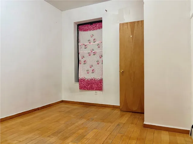 an empty room with a painting on the wall