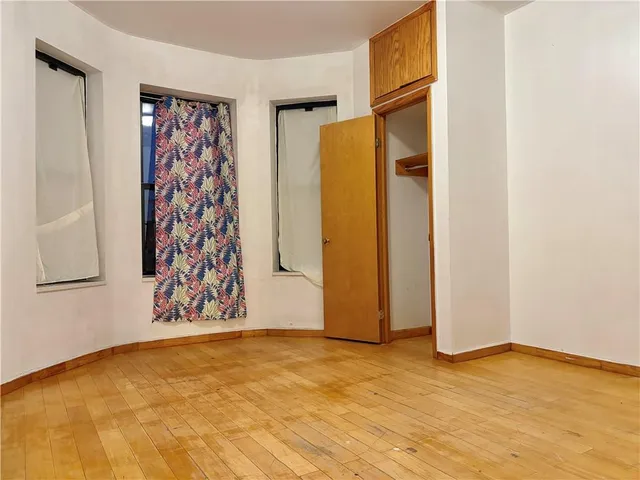 a view of an empty room with window and gate