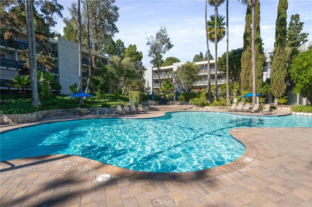 3604 West Estates Lane, Unit 117 Rolling Hills Estates, CA 90274 - Photo 1 of 36 a view of a garden with a fountain in front of the house