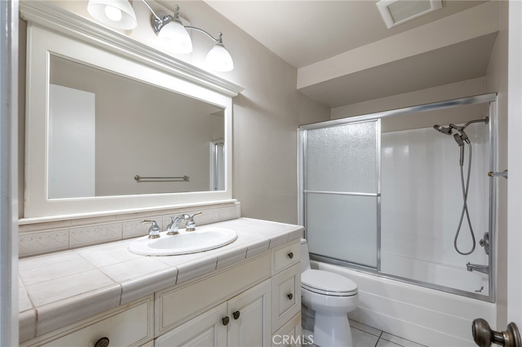 3604 West Estates Lane, Unit 117 Rolling Hills Estates, CA 90274 - Photo 12 of 36 a bathroom with a granite countertop sink toilet and shower