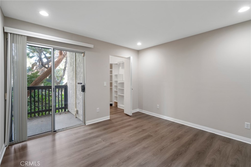 3604 West Estates Lane, Unit 117 Rolling Hills Estates, CA 90274 - Photo 14 of 36 an empty room with wooden floor and windows