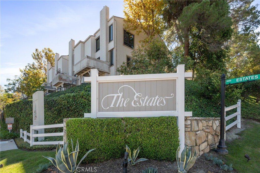 3604 West Estates Lane, Unit 117 Rolling Hills Estates, CA 90274 - Photo 2 of 36 a sign broad in front of the red brick house