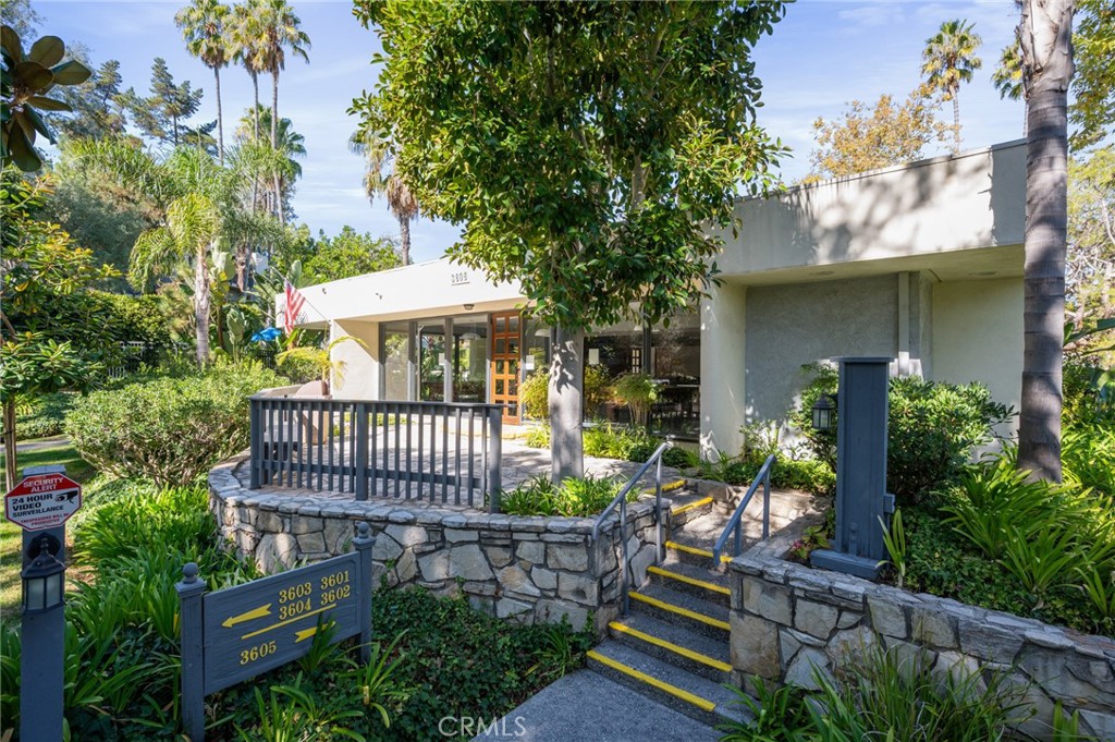 3604 West Estates Lane, Unit 117 Rolling Hills Estates, CA 90274 - Photo 23 of 36 a view of a deck with a table and chairs under an umbrella