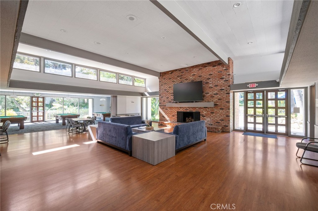 3604 West Estates Lane, Unit 117 Rolling Hills Estates, CA 90274 - Photo 25 of 36 a living room with fireplace furniture and a flat screen tv