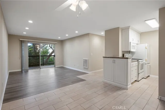 a view of a kitchen with a refrigerator and a sink