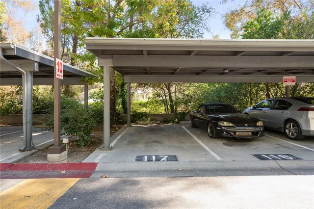 a front view of a house with garden and trees