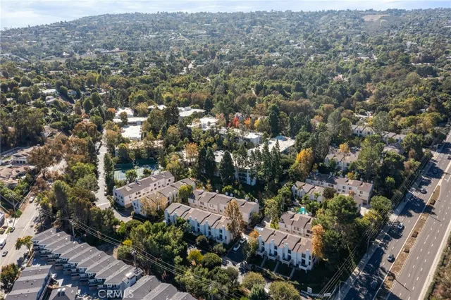 an aerial view of a house with a yard and garden