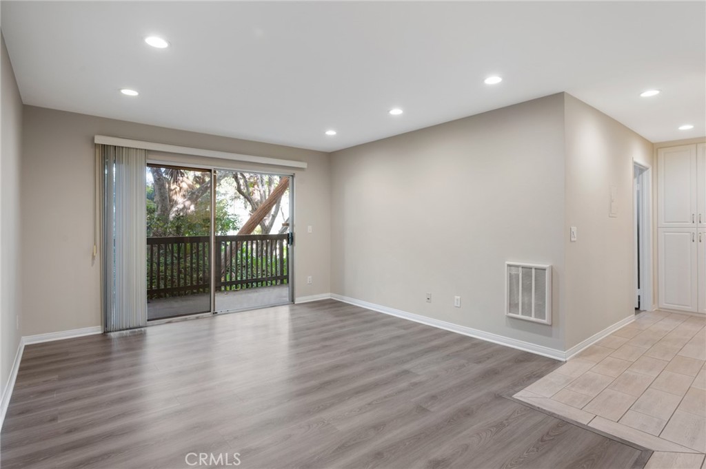 3604 West Estates Lane, Unit 117 Rolling Hills Estates, CA 90274 - Photo 5 of 36 an empty room with wooden floor and windows