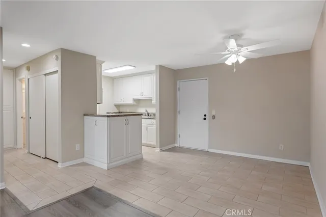 a view of a kitchen with a sink and a refrigerator