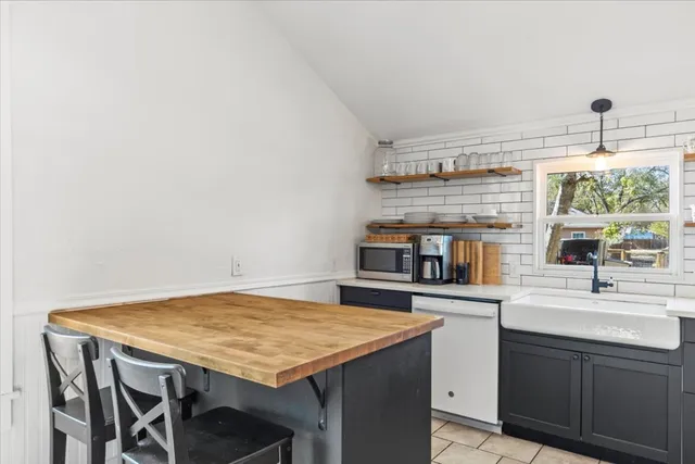 a kitchen with stainless steel appliances granite countertop a sink and cabinets