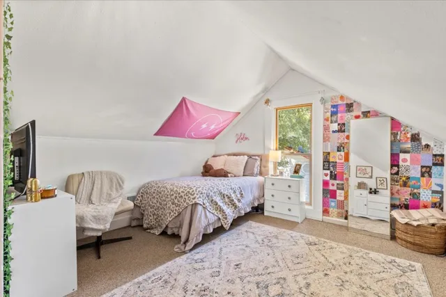 a bedroom with bed and a couch