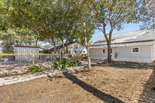 front view of a house with a large tree