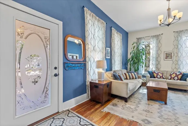 a living room with furniture and painting on the wall