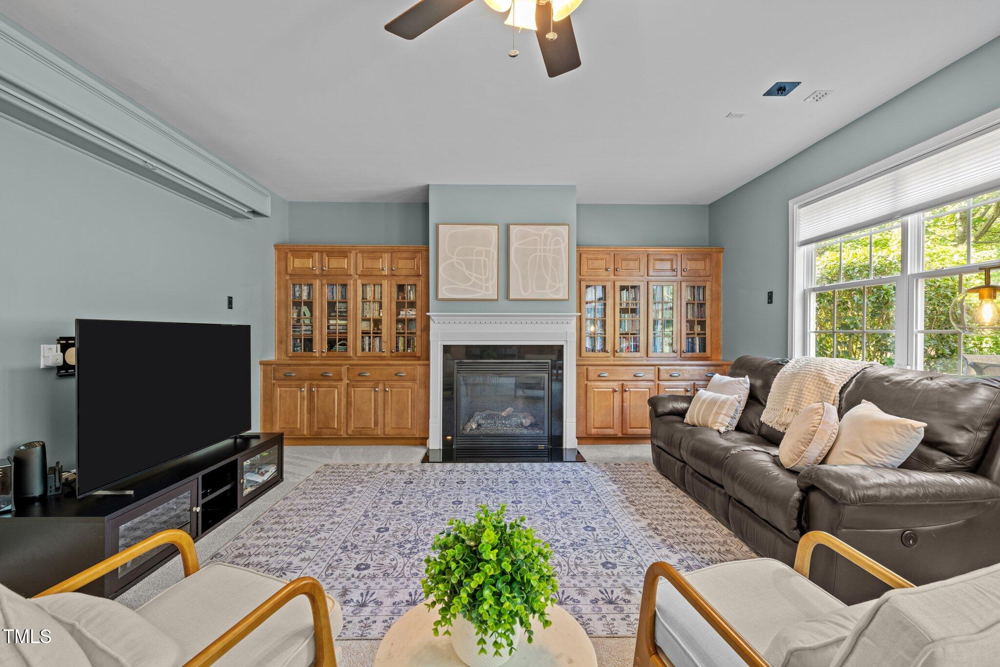 705 Harkness Circle Durham, NC 27705 - Photo 13 of 58 a living room with furniture a fireplace and a flat screen tv