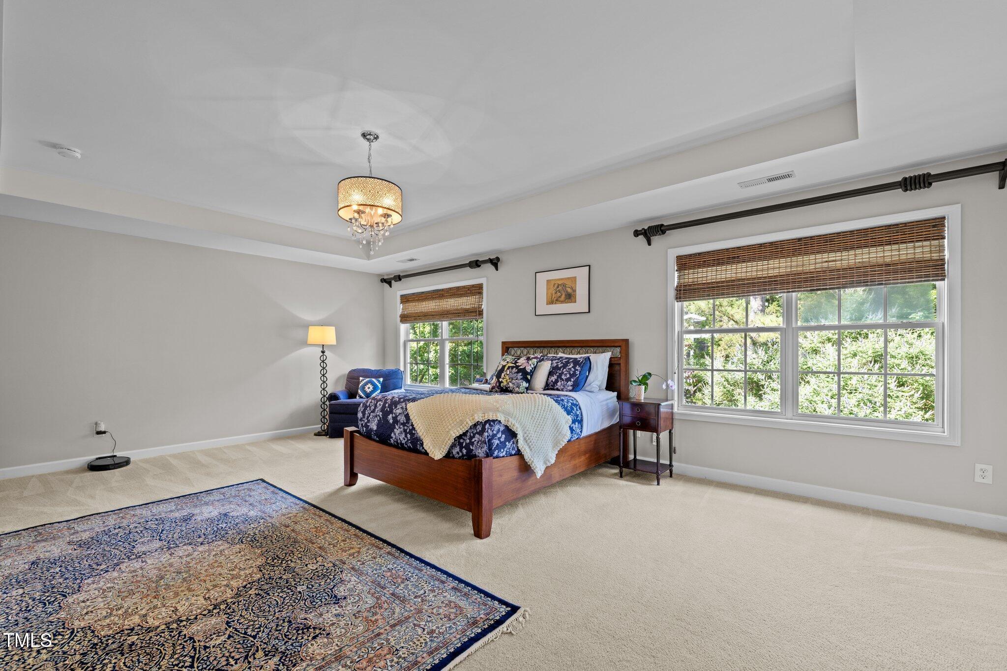 705 Harkness Circle Durham, NC 27705 - Photo 18 of 58 a spacious bedroom with a bed and a window