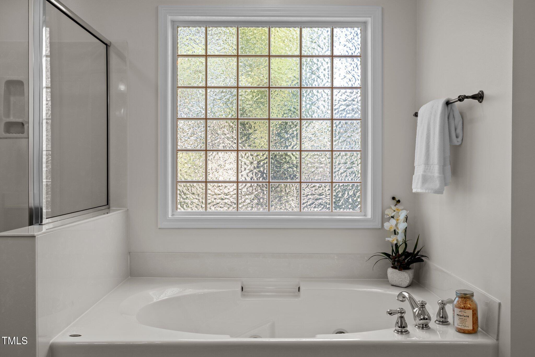 705 Harkness Circle Durham, NC 27705 - Photo 20 of 58 a bathroom with a bathtub and a window