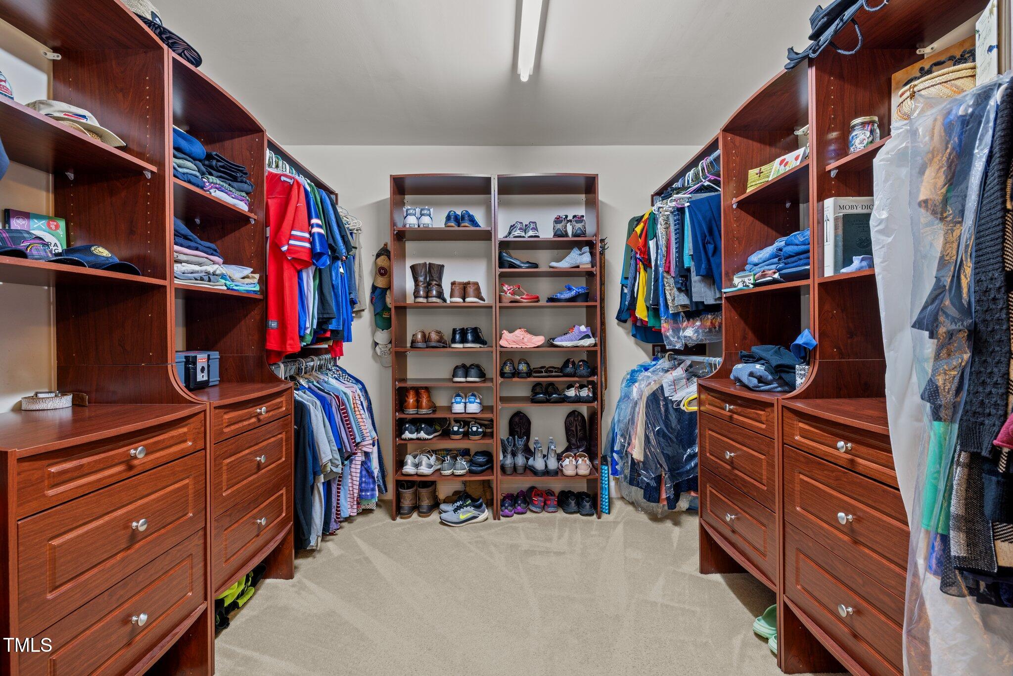 705 Harkness Circle Durham, NC 27705 - Photo 23 of 58 a view of walk in closet with clothes and shoes