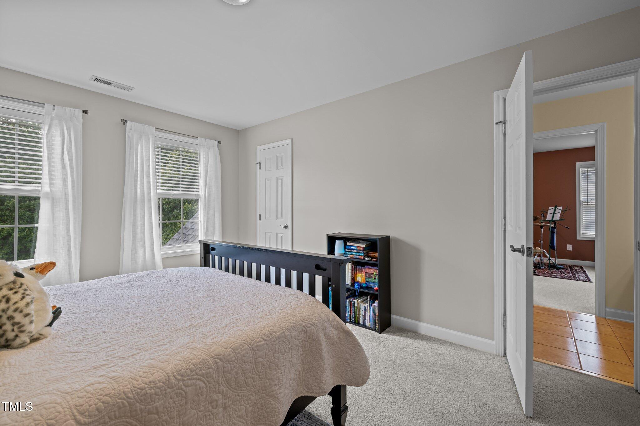 705 Harkness Circle Durham, NC 27705 - Photo 26 of 58 a bedroom with a bed and a window